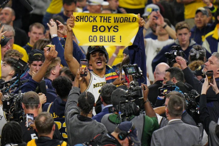 Yaxel Lendeborg, Michigan's star celebrates with the Shock the World banner.